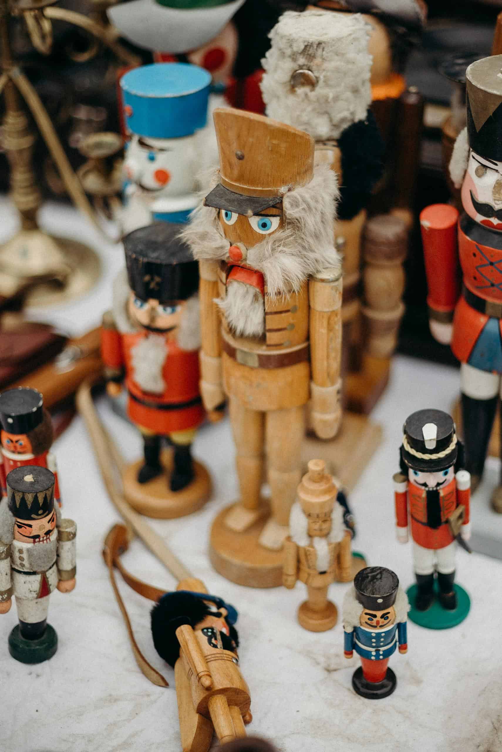 A collection of wooden nutcrackers displayed at a festive Christmas market, showcasing intricate designs.