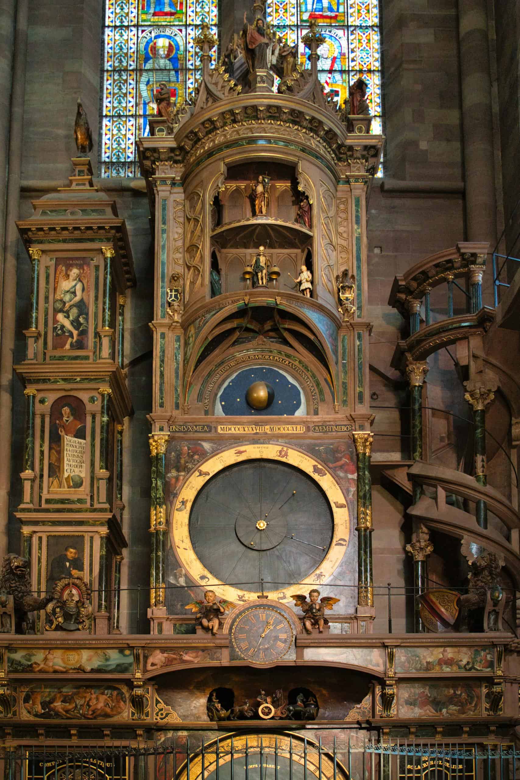 A detailed view of the Strasbourg astronomical clock inside the cathedral, showcasing its intricate design and historical significance.