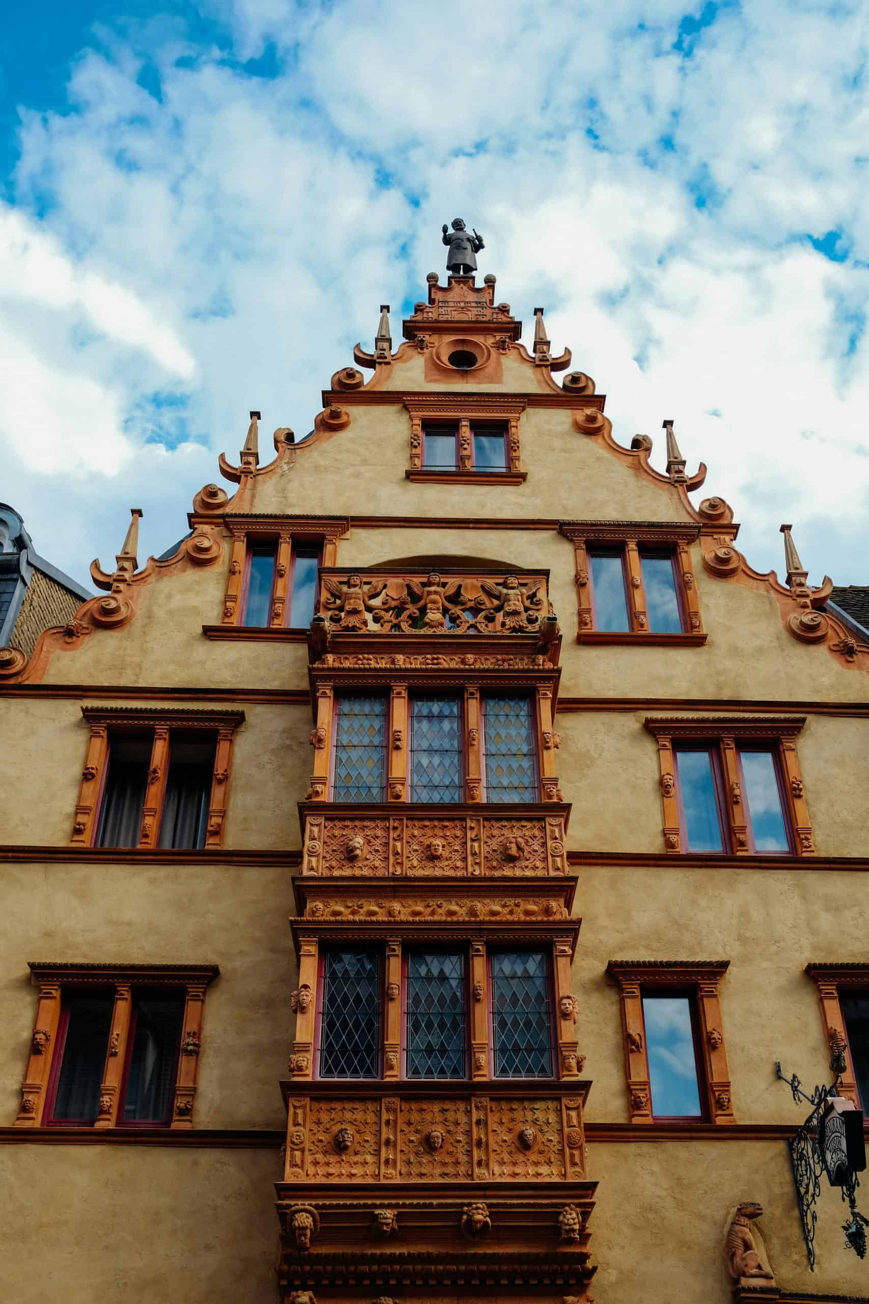 Ornate historic facade of the House of Heads in Colmar with intricate architectural details.
