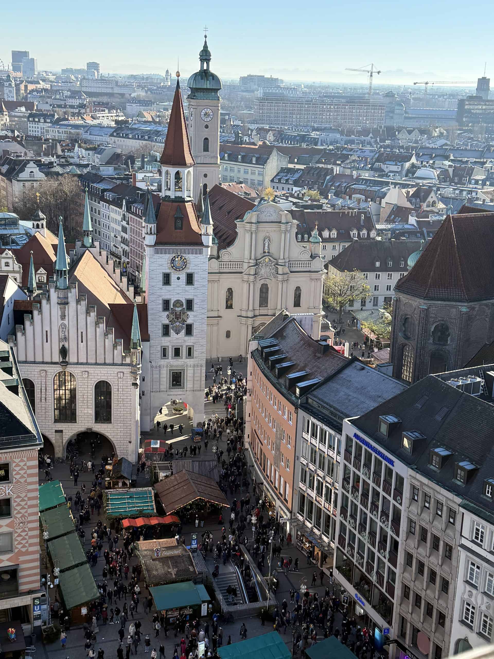 Beautiful aerial view of Marienplatz in Munich, Germany, showcasing historic architecture and bustling holiday market atmosphere.