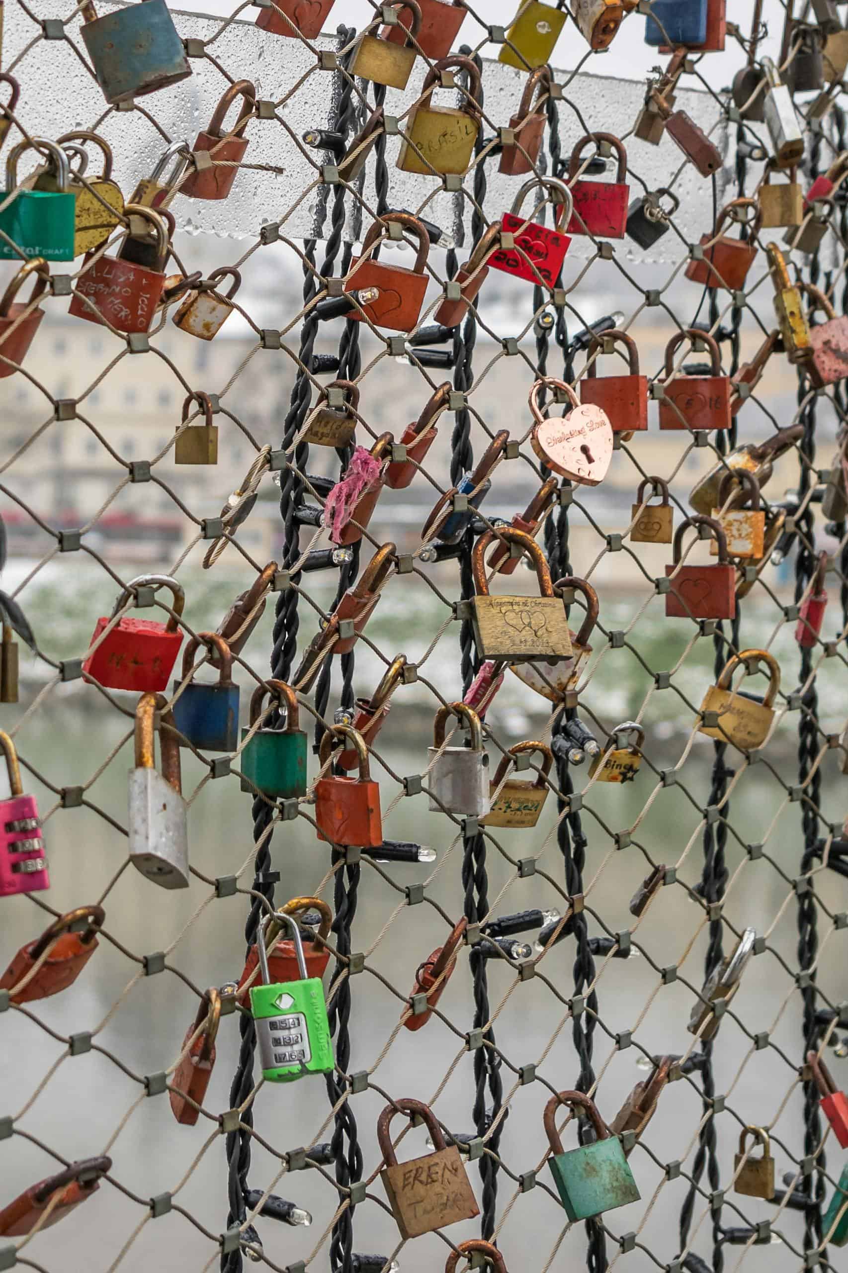 Close-up of colorful love padlocks on a bridge fence in Salzburg, Austria.