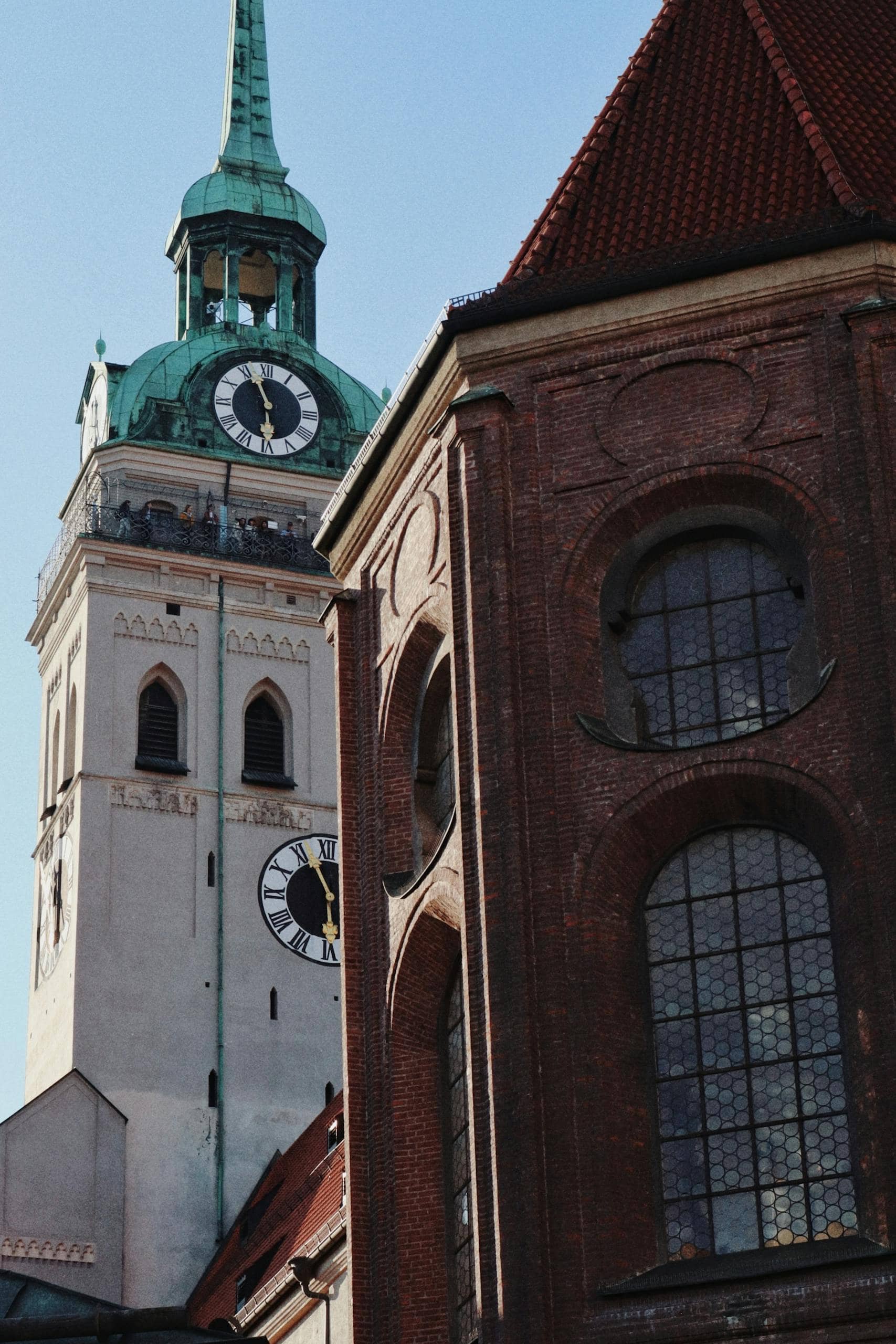 View of St. Peter's Church clock tower with historical architecture in Munich, Germany.