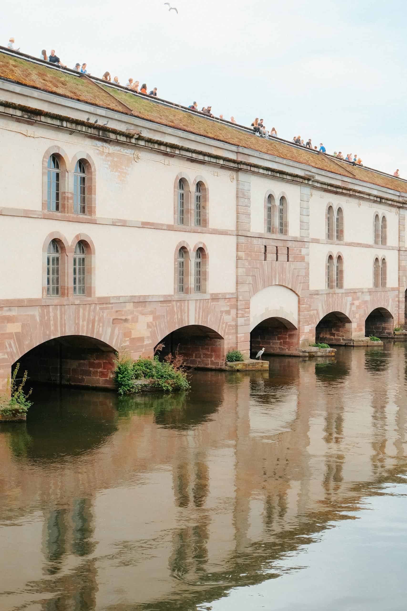 Picturesque view of Barrage Vauban in Strasbourg, reflecting on Ill River's calm waters.