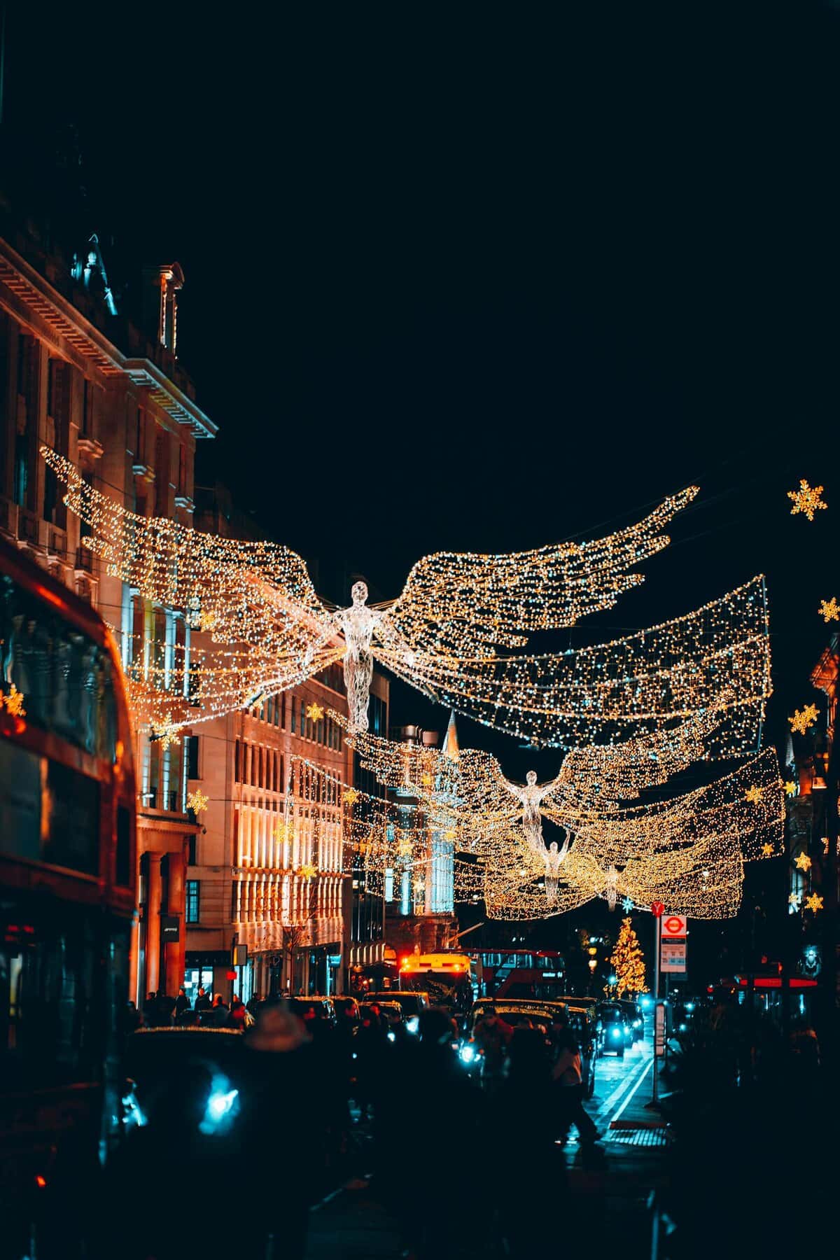 Illuminate the festive spirit with stunning angel light decorations on London streets at night.