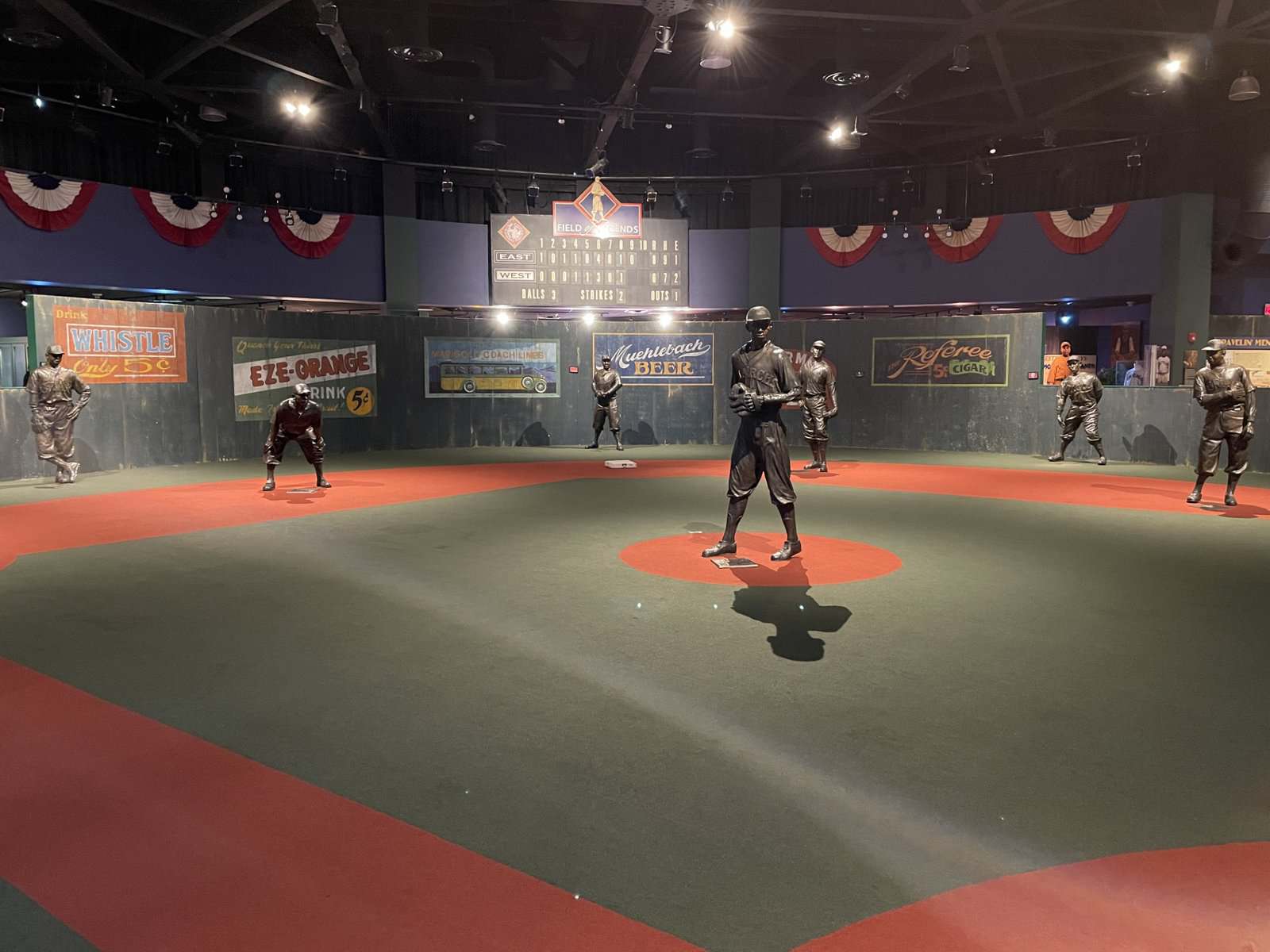 Indoor small-scale baseball field exhibit featuring Negro Leagues players.