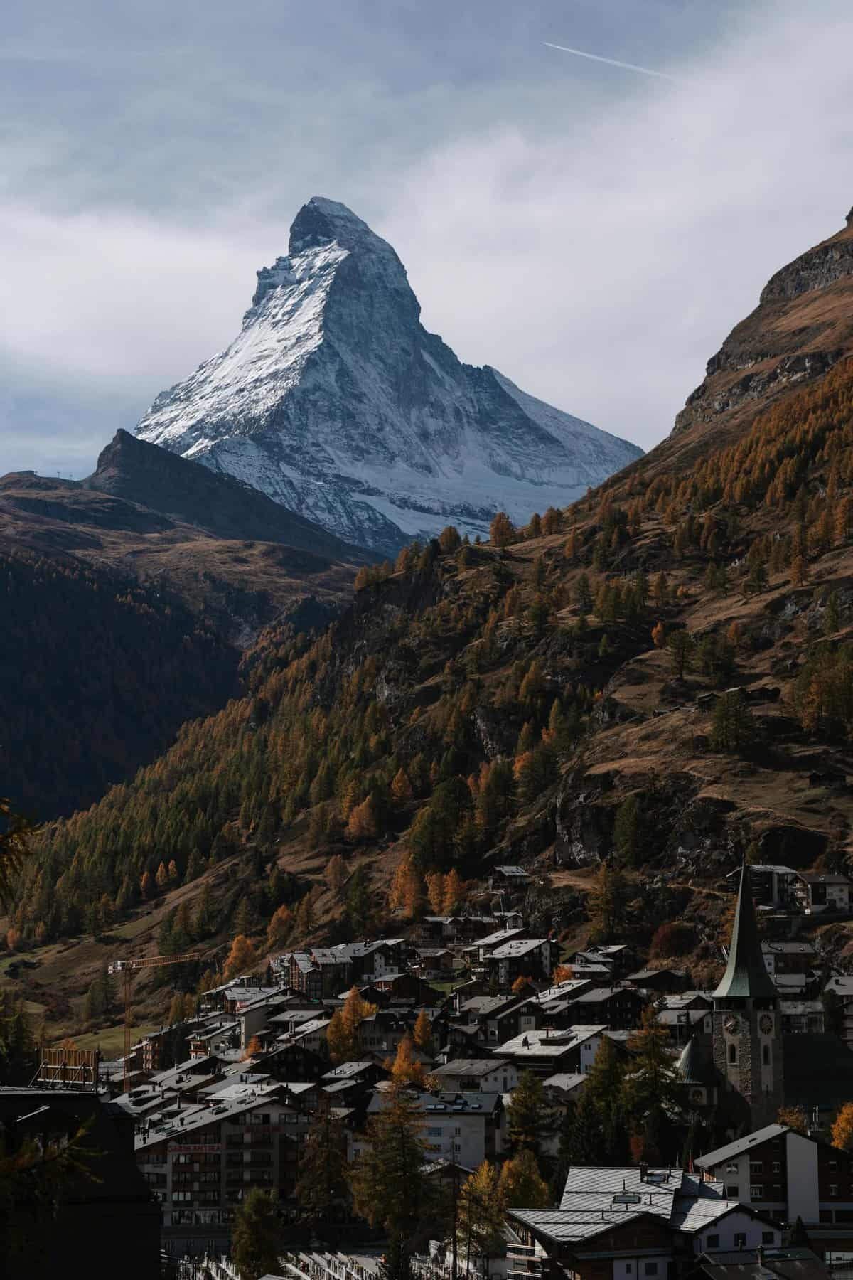 Captivating autumn landscape of Zermatt with the iconic Matterhorn peak in the background.