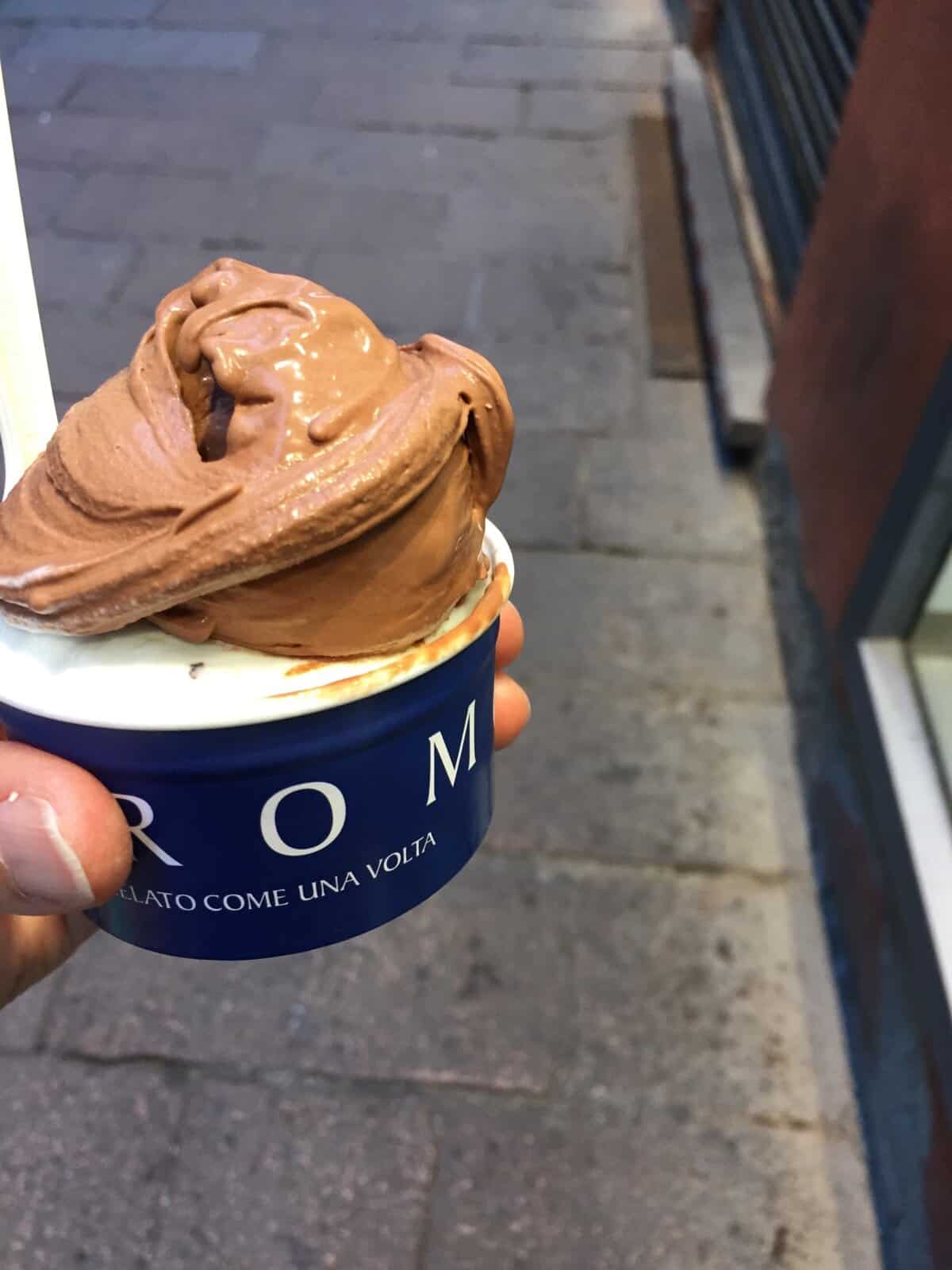 Creamy chocolate gelato in a blue cup, perfect for summer date or treat.