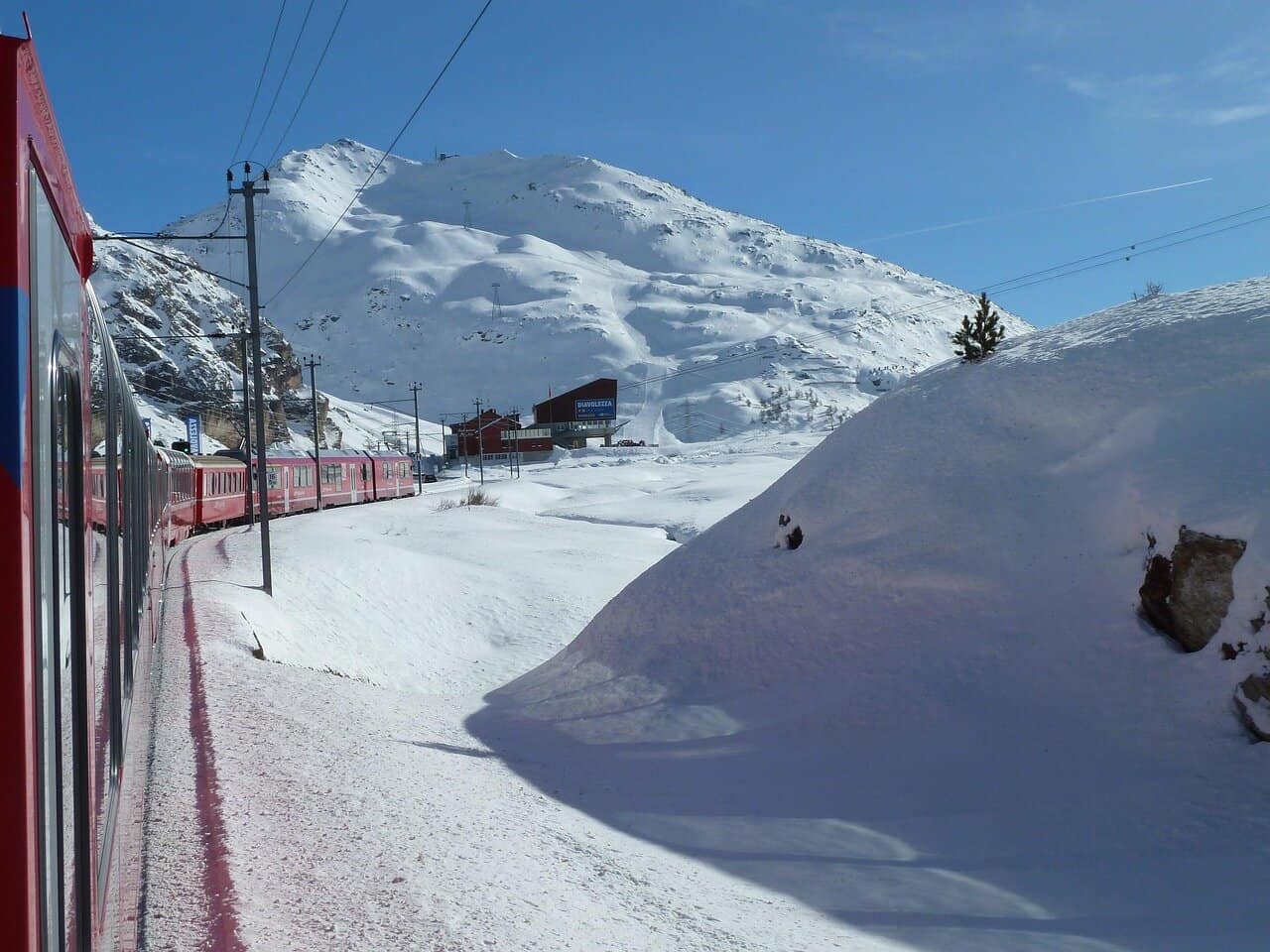 Glacier Express Panoramic Train traveling through mountains and snow