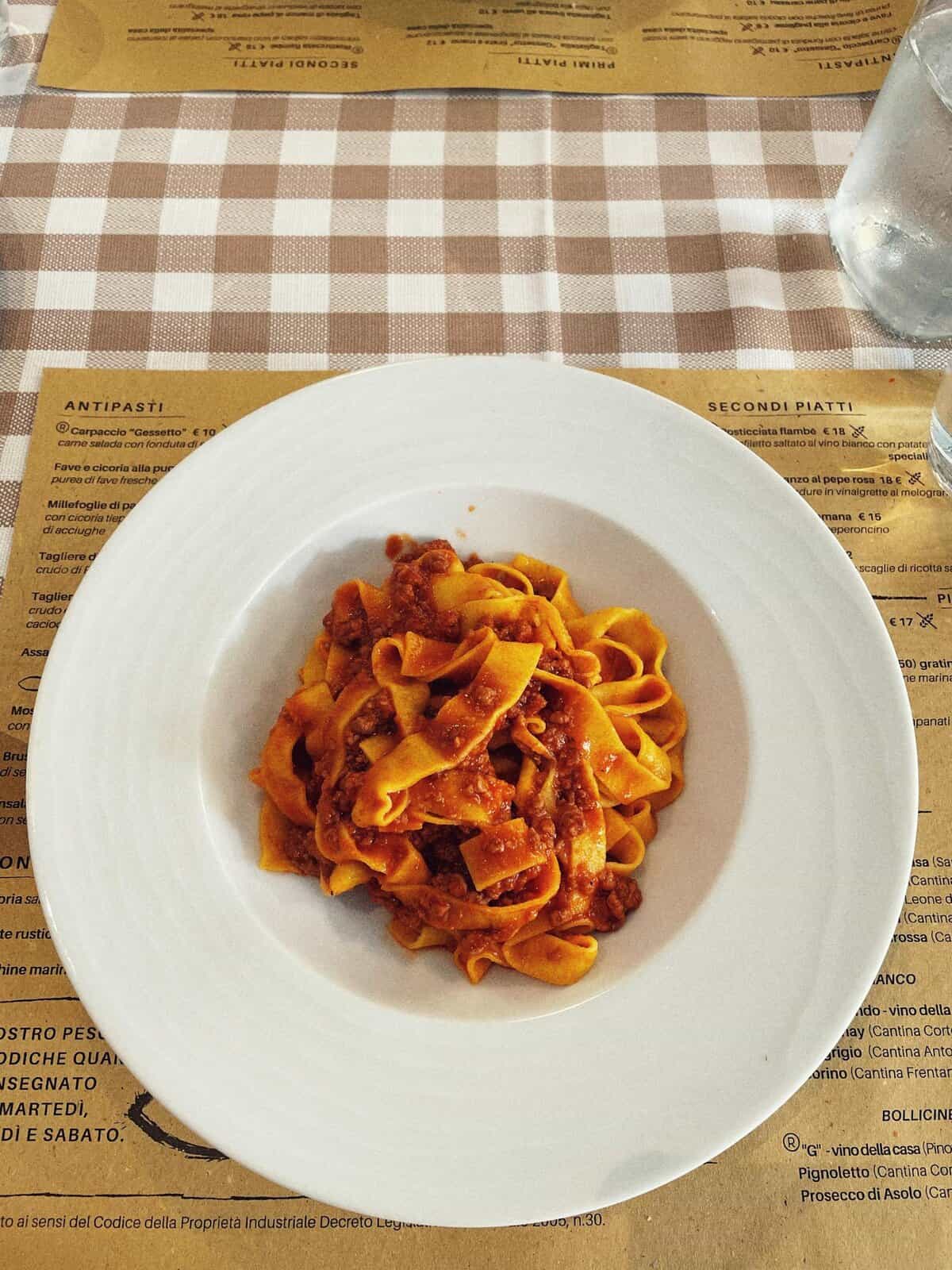 Savor the authentic taste of Italian tagliatelle with rich ragu sauce, served in Bologna.