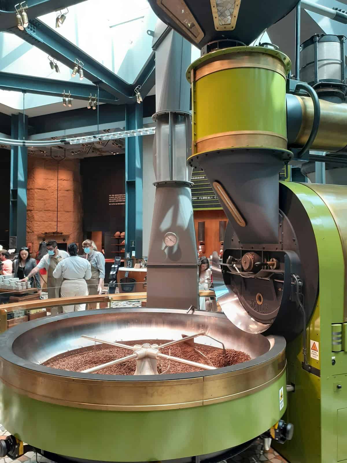 A glimpse into a chocolate factory featuring machinery and visitors in an industrial setting.