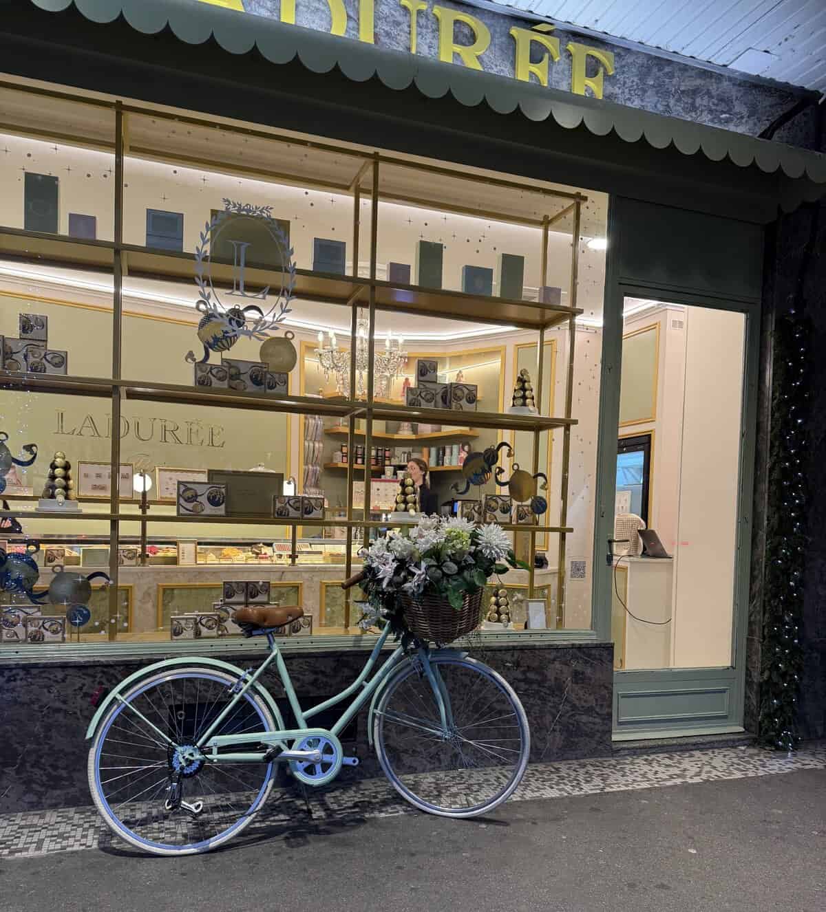 Ladurée café storefront in Montreux with decorative bicycle and flowers