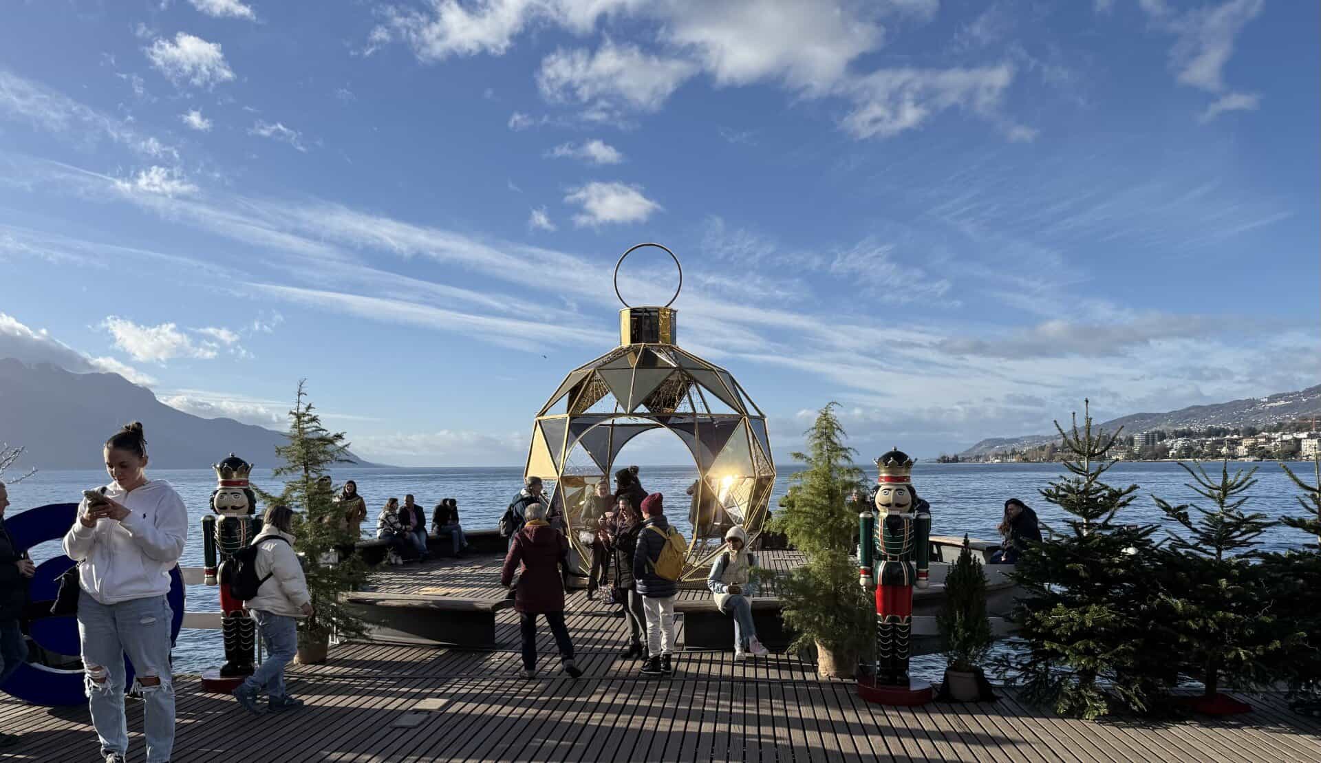 Festive photo spot at the Montreux Christmas Market with nutcrackers and Lake Geneva views