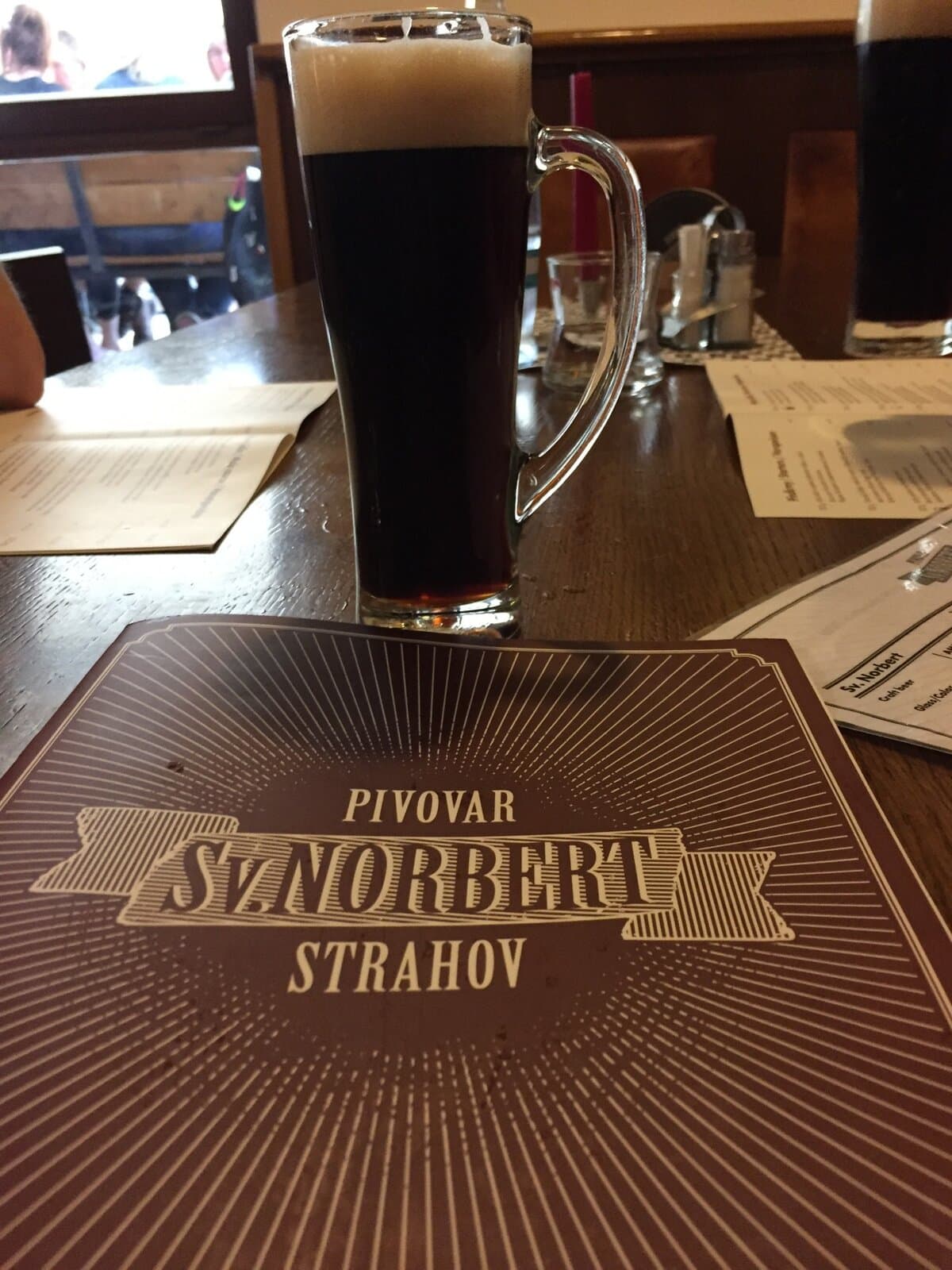 Dark Czech beer in a tall glass at Pivovar Strahov Monastery Brewery in Prague.