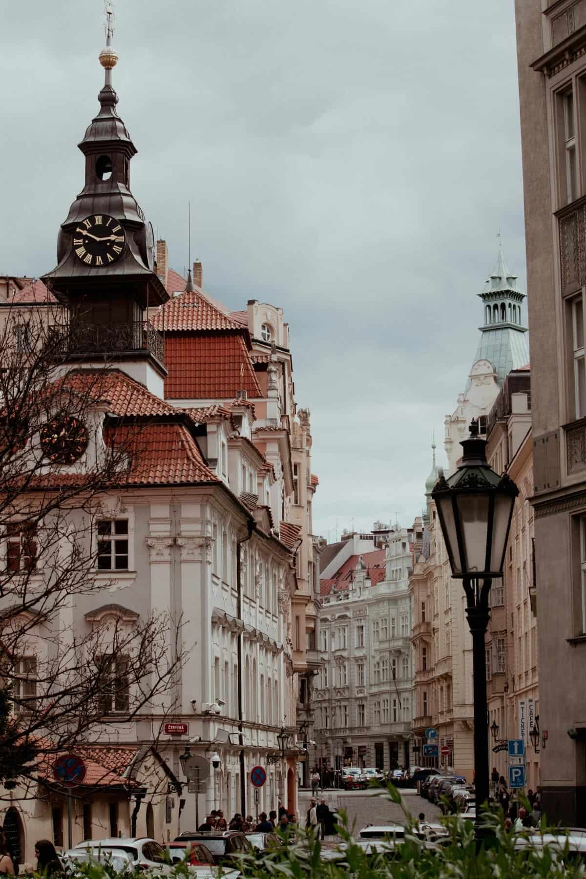 Explore the captivating historic architecture of Prague's Jewish Town Hall and surroundings on a cloudy day.