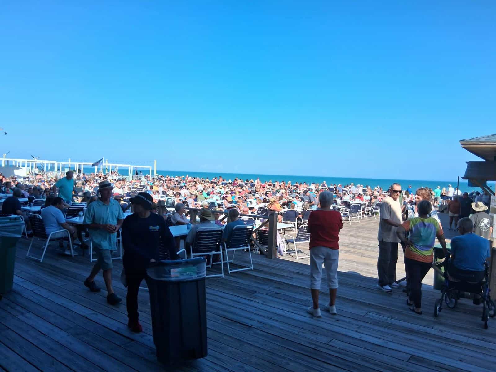 Crowd at Louie’s Backyard in South Padre Island with oceanfront views
