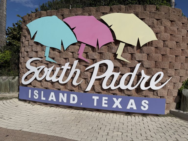 South Padre Island Texas welcome sign with colorful beach umbrellas