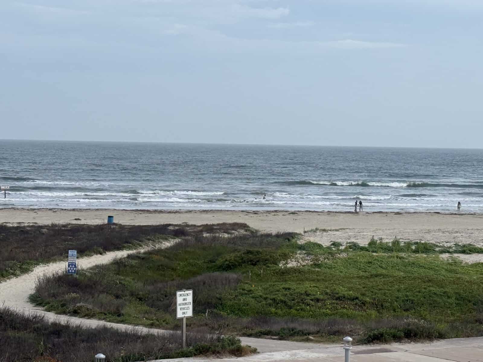 Path leading to Galveston beach with ocean views and sandy shoreline