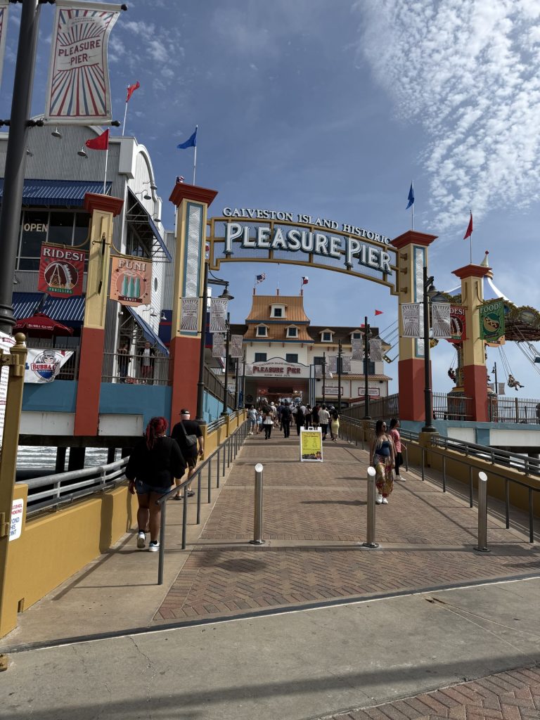 Entrance to Galveston Island Historic Pleasure Pier with visitors walking in
