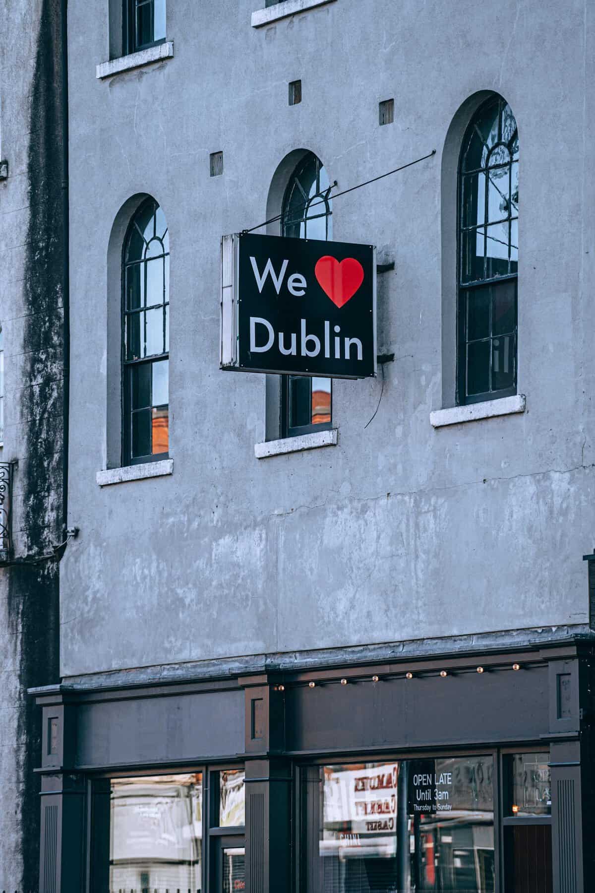Sign with 'We ❤️ Dublin' on a historic building exterior in Dublin, Ireland.