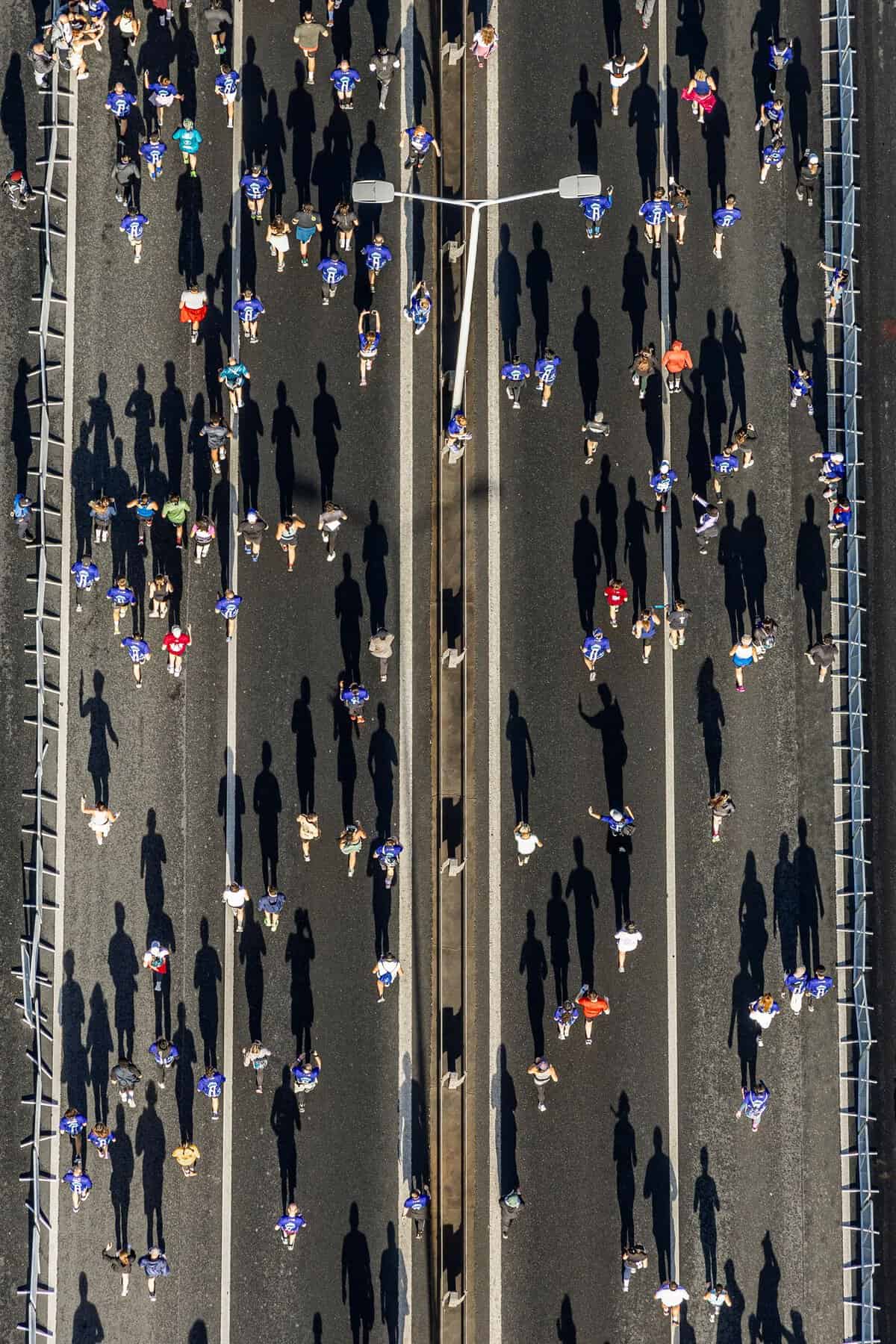 Aerial photo capturing marathon runners casting long shadows on İstanbul street.