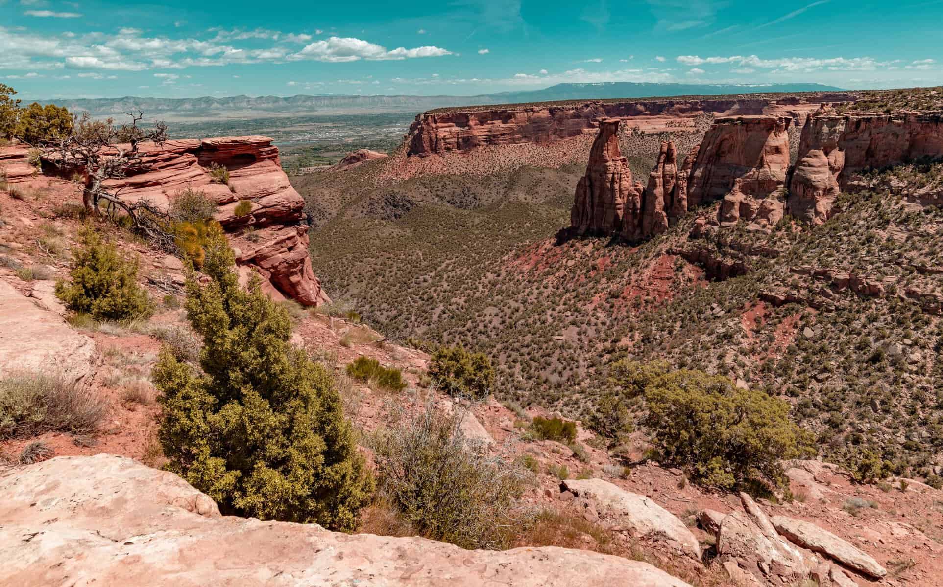 Breathtaking view of Colorado National Monument's rugged rock formations under a clear blue sky.