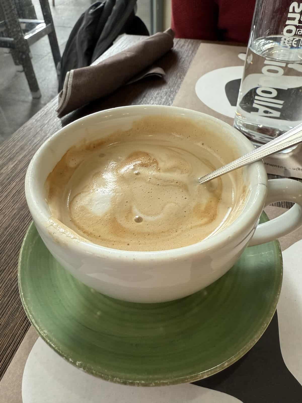 Large café latte served in a ceramic mug.