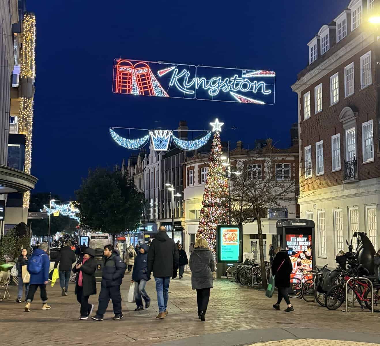 Christmas lights and holiday decorations hanging above Kingston Upon Thames town center at nigh