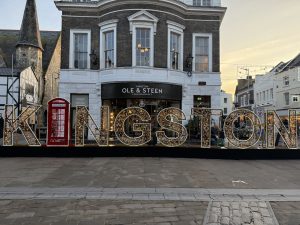Illuminated Kingston sign and holiday decorations in Kingston Upon Thames town center
