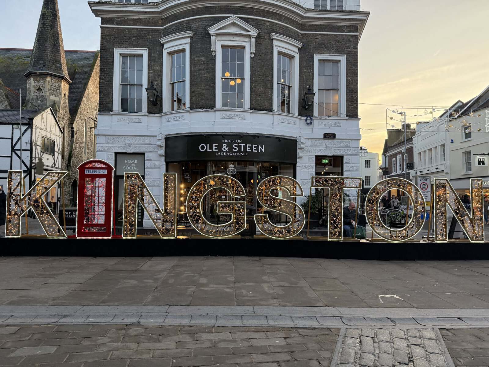Illuminated Kingston sign and holiday decorations in Kingston Upon Thames town center