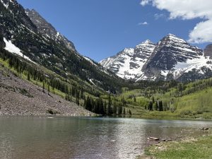 Maroon Bells reflected in Maroon Lake near Aspen, Colorado on a sunny spring day