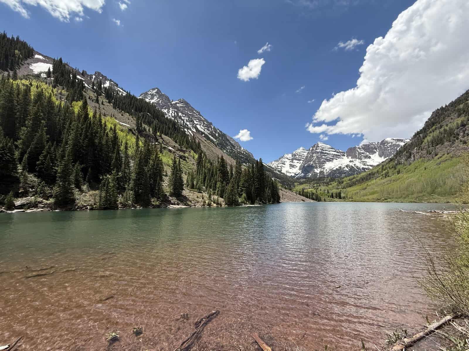 Maroon Lake with clear water and snow-capped Maroon Bells peaks near Aspen, Colorado
