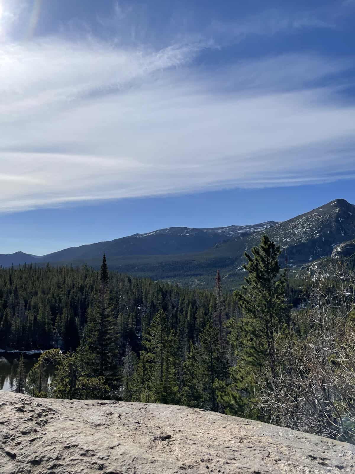Mountain views overlooking forests and snow-capped peaks in Rocky Mountain National Park, Colorado.