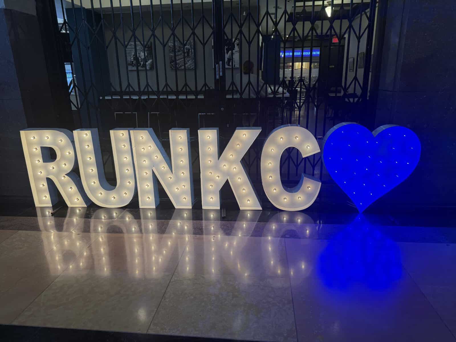 Illuminated RUN KC sign displayed indoors during Kansas City Marathon race weekend festivities.