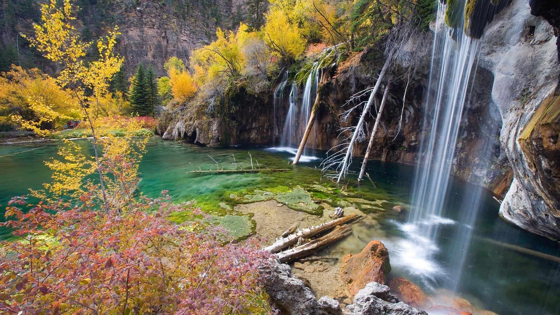 Hanging Lake in Colorado with turquoise water, waterfalls, and colorful fall foliage