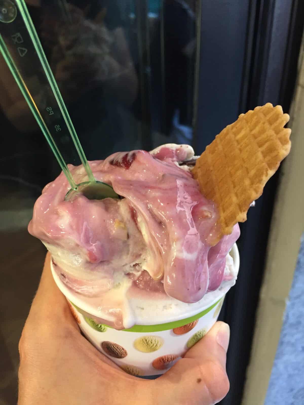 Cup of creamy Italian gelato with a wafer cookie in Rome