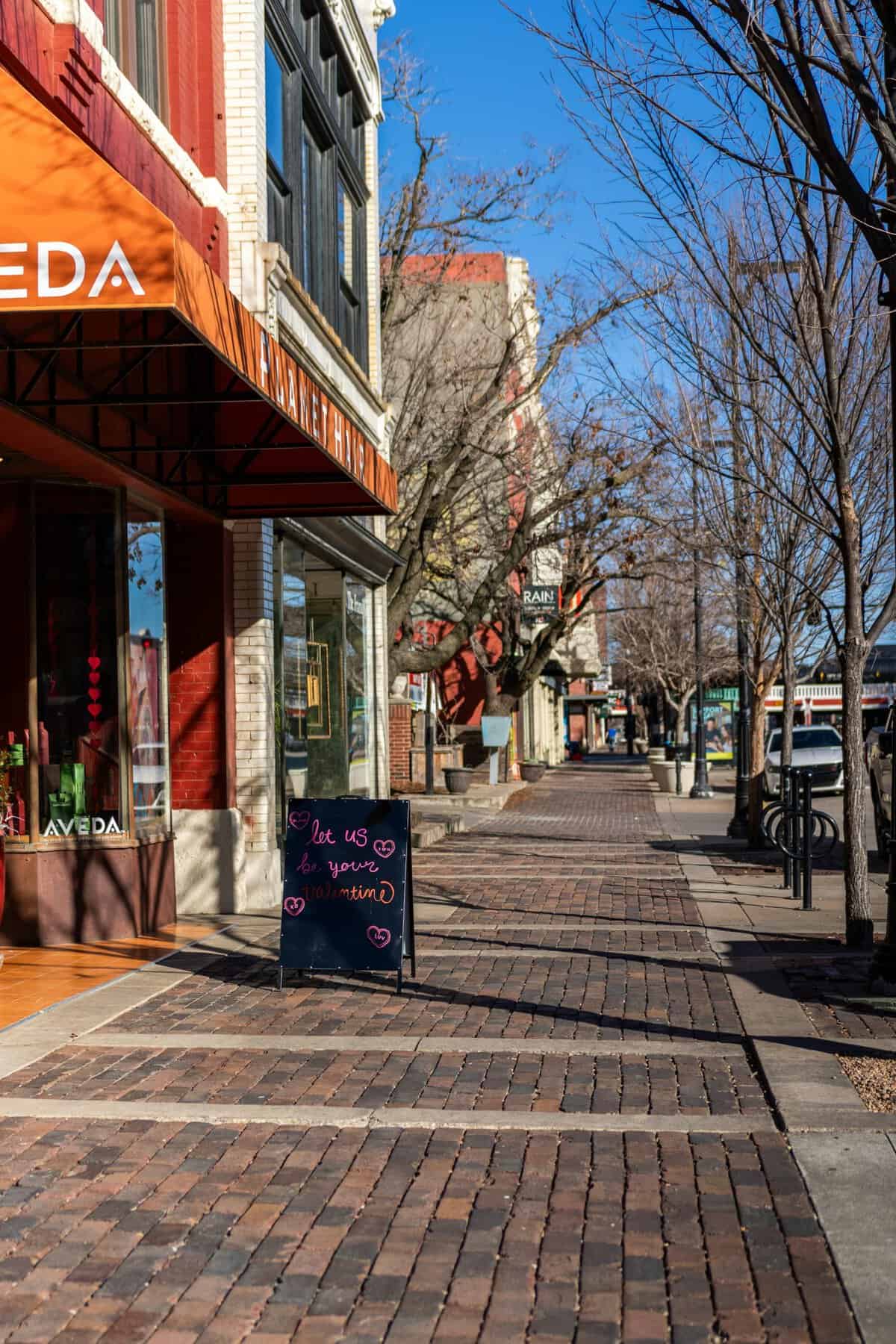 Brick-lined sidewalk with local shops in Old Town Wichita, Kansas