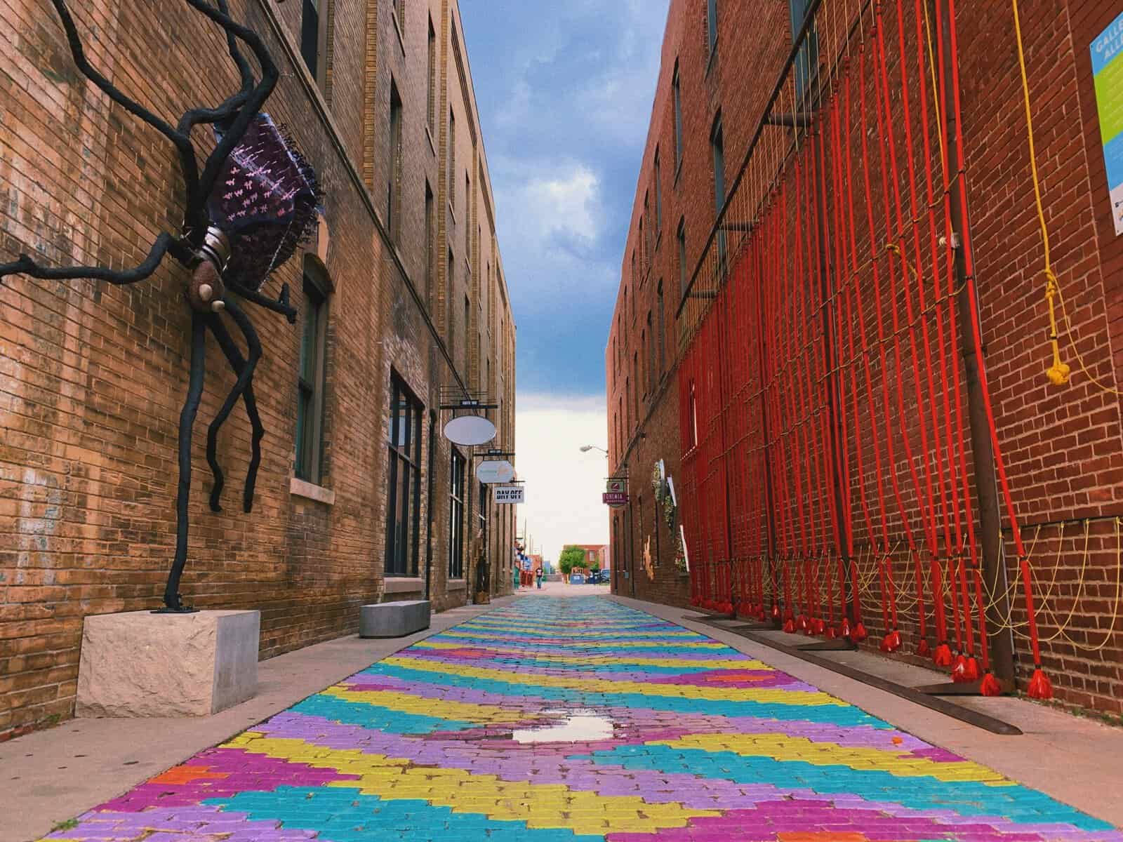 Colorful public art alley with brick buildings in Wichita, Kansas