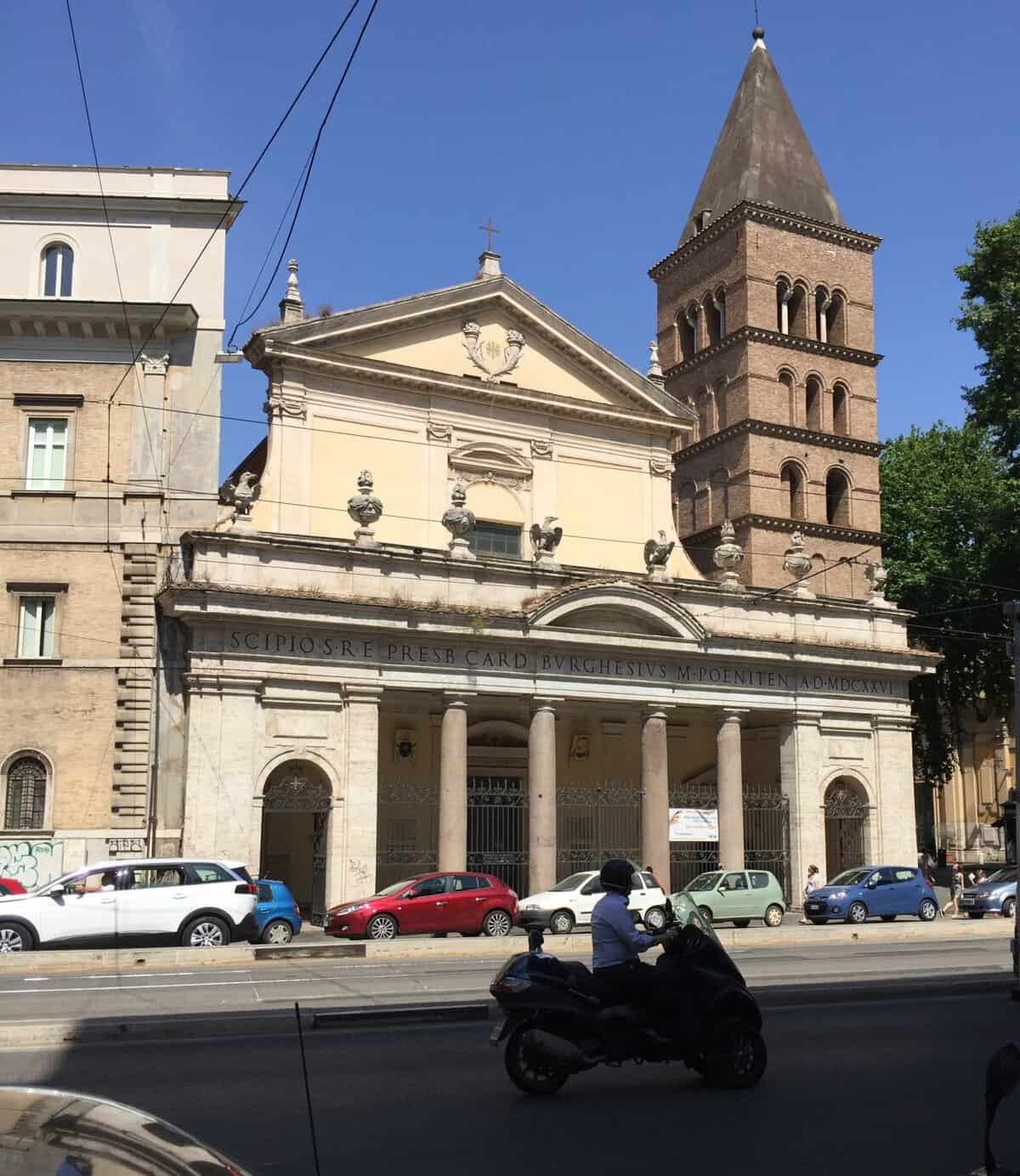 Historic Church and bell tower along a street in the Trastevere neighborhood of Rome
