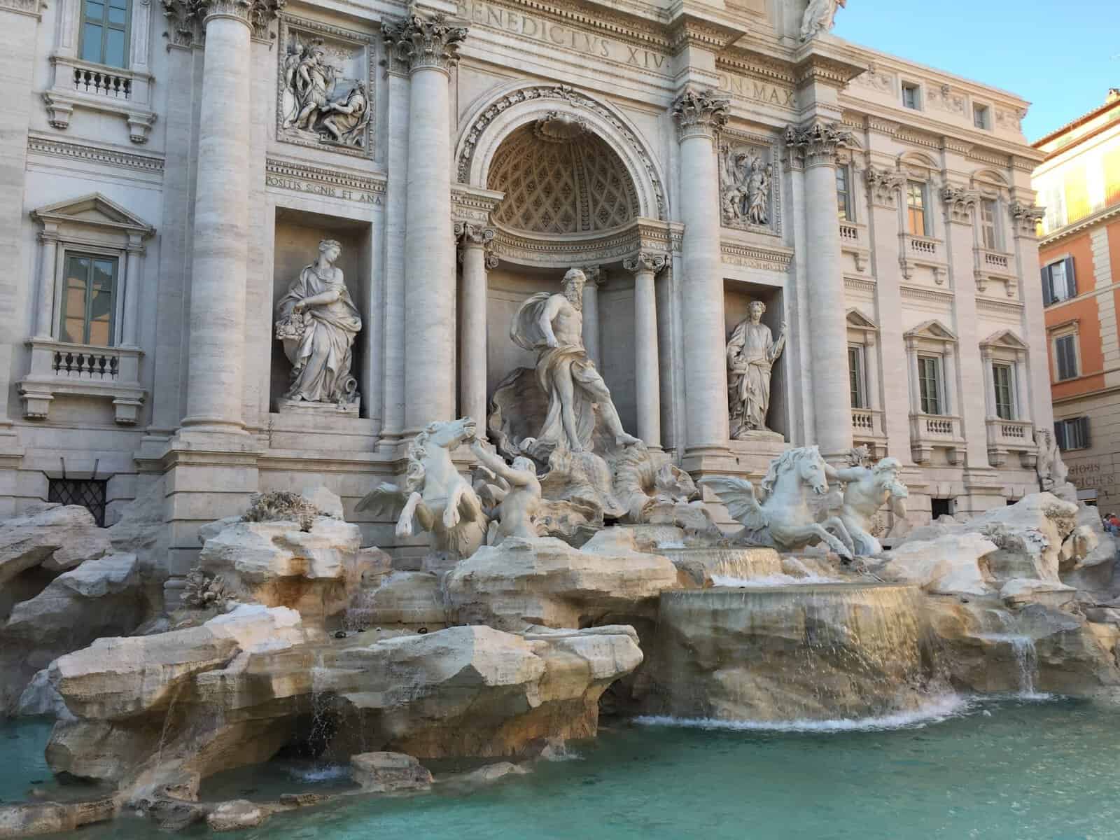 Trevi Fountain in Rome with its Baroque statues, cascading water, and turquoise pool.
